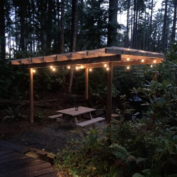 covered lighted outdoor seating at the yurt