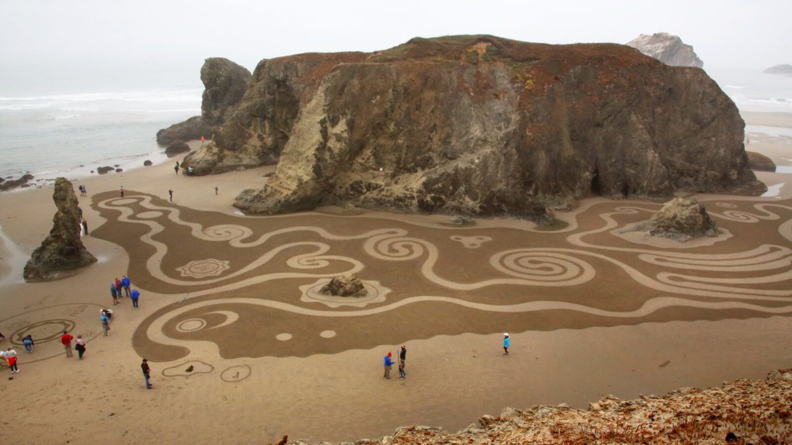 aerial view of Tourists at the Bandon Beach with designs on the sand
